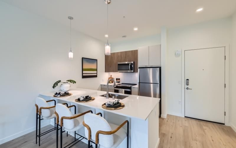 wood-grain cabinets with a large island and stools