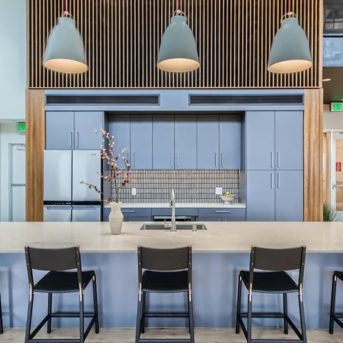 a spacious kitchen with a large island and chairs