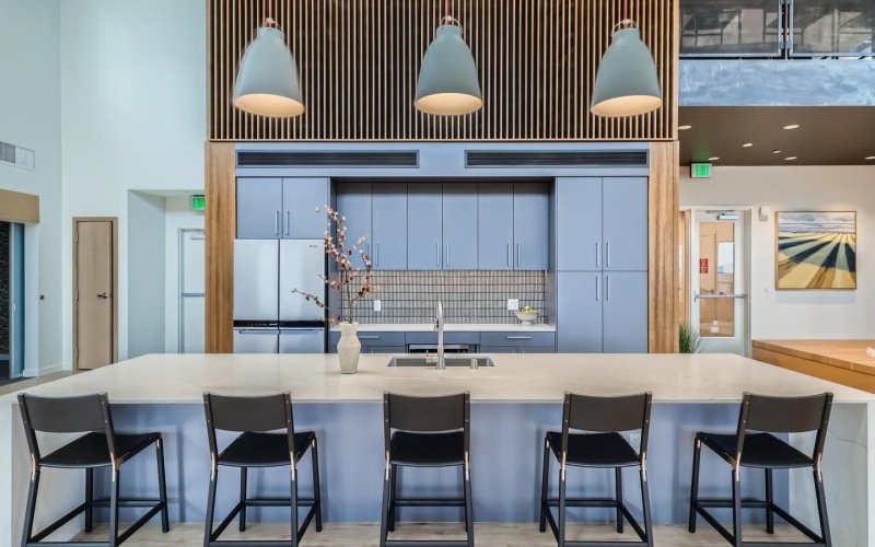 a spacious kitchen with a large island and chairs