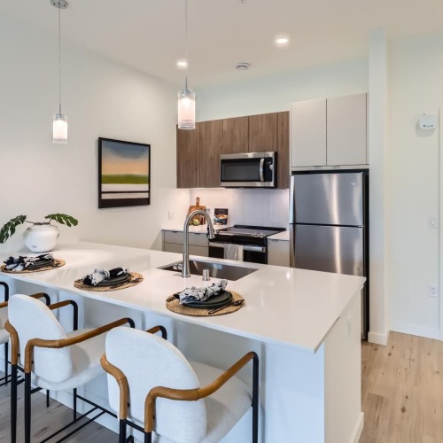 wood-grain cabinets with a large island and stools