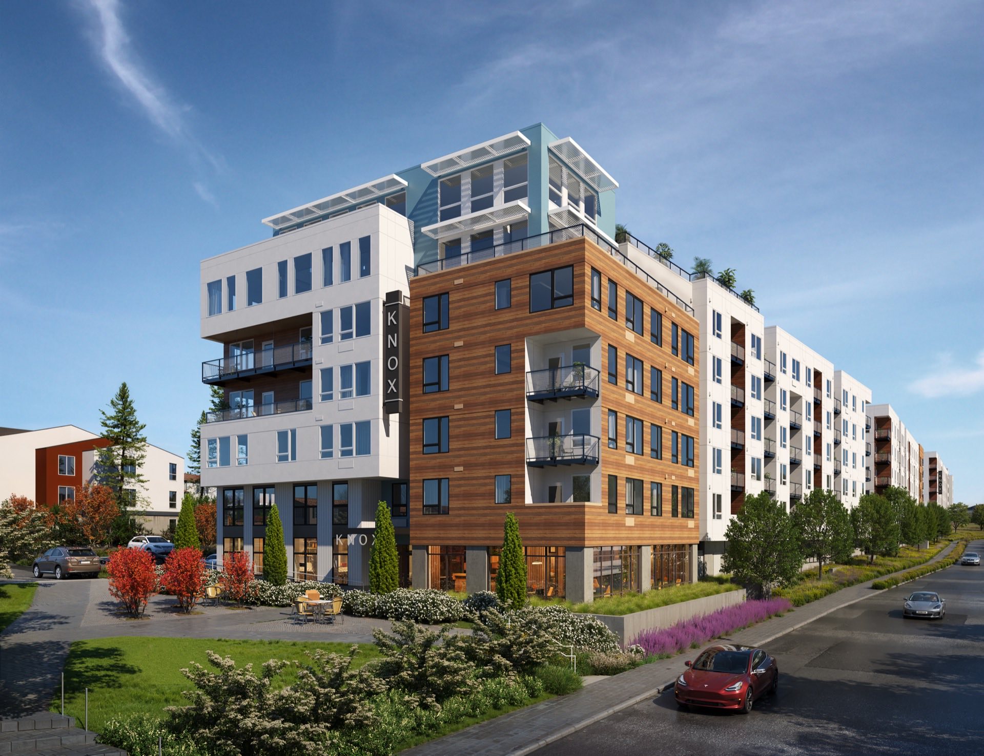 Seven-story modern architecture building with brown and white facade against a blue sky.